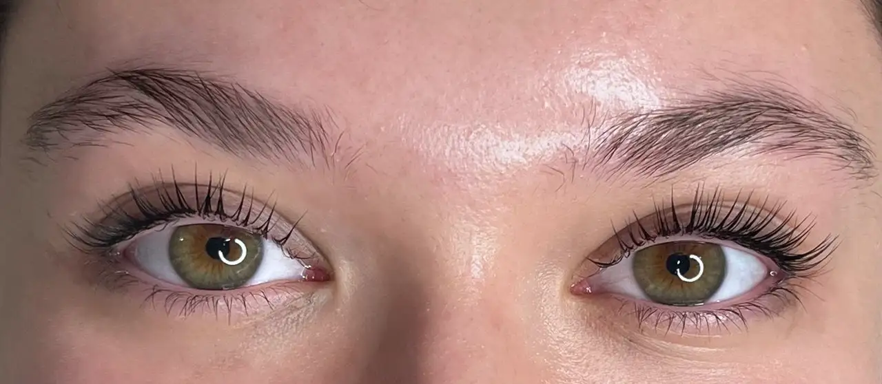 Nahaufnahme von Augen mit gelifteten Wimpern und natürlich gepflegten Augenbrauen